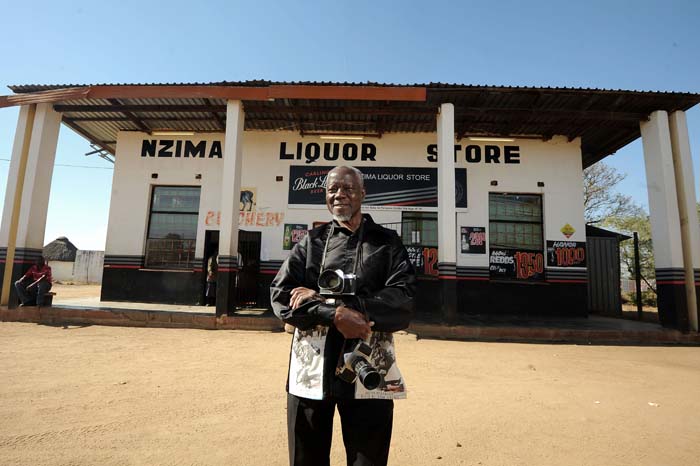 Photojournalist Sam Nzima in front of his liquour store in Lillydale
